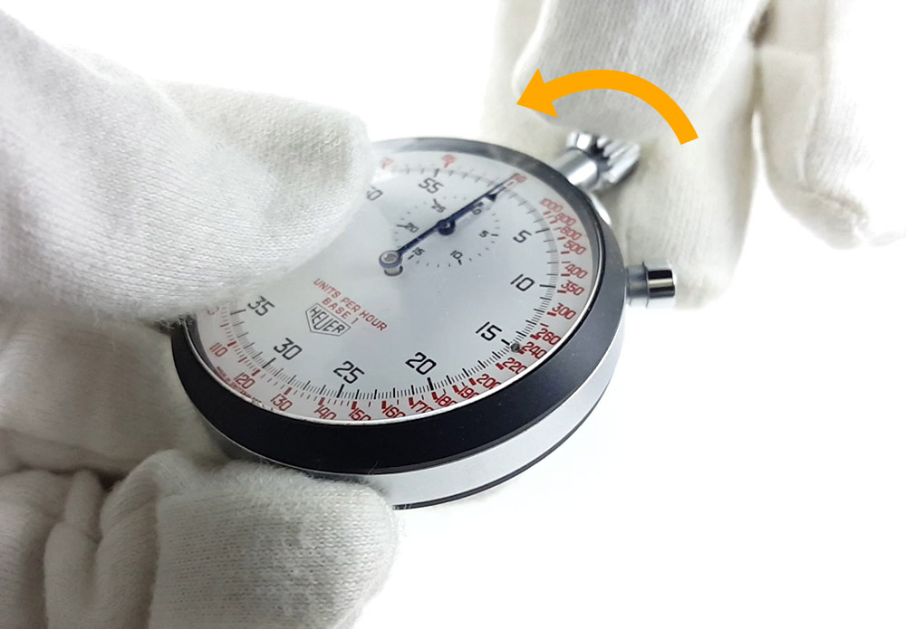 How to wind up a mecanical HEUER stopwatch --- turning the crown (thumbnail picture) --- ikonicstopwatch.com